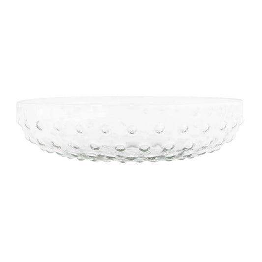 Two RECYCLED GLASS HOBNAIL SERVING BOWLS by CREATIVE COOP sit on a textured surface, one with a mixed green salad and the other with a grain-based salad. Gold scissors rest beside the larger bowl, while three stalks of lemongrass decorate the left.