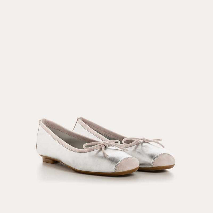 Top view of the REQINS - HARMONY BALLERINA FLATS IN METALIC SILVER by REQINS, featuring shimmering silver leather and a front bow, captured on a plain light background for a chic metallic look.