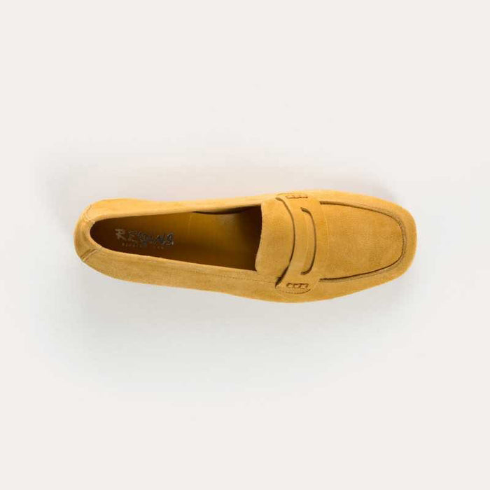 The REQINS - HEMA Suede Loafer in Ochre, expertly crafted by REQINS, features a low heel and a decorative front strap, shown against a plain light background.