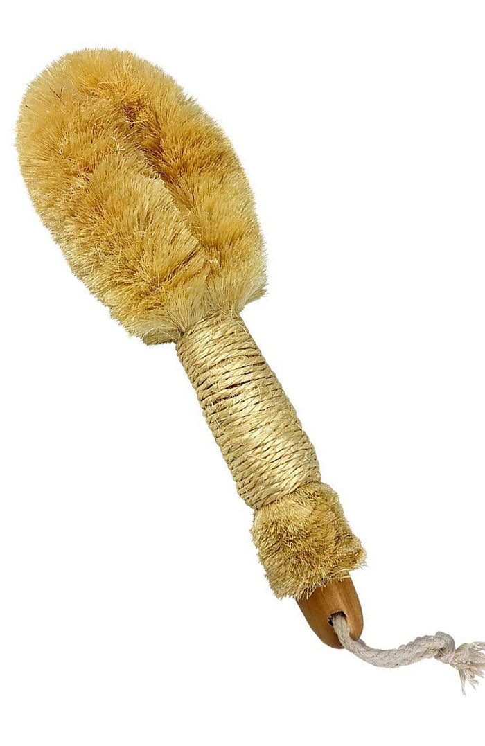 A sisal dry brush with a straw-colored handle and natural bristles, designed for skin care.