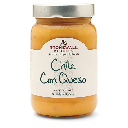 A jar of STONEWALL KITCHEN - CHILI CON QUESO, a creamy and spicy queso dip. The jar features a silver lid and a white label with green text, displaying "CHILI CON QUESO" and "Gluten Free." The net weight is 445g (16 oz).
