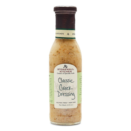 The STONEWALL KITCHEN - CLASSIC GREEK DRESSING is displayed in an 11-ounce frosted glass bottle. The bottle features a green label adorned with black text and topped with a brown cap. Prominently highlighted on the label are the "Gluten Free" and "Non-GMO" attributes, embodying traditional flavors ideal for any Greek salad.
