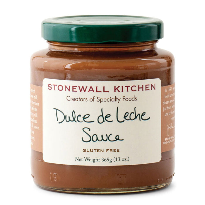 A glass jar of STONEWALL KITCHEN- DULCE DE LECHE SAUCE with a green lid, labeled gluten free, net weight 369g (13 oz.)—perfect for adding a Caribbean twist to your favorite desserts.