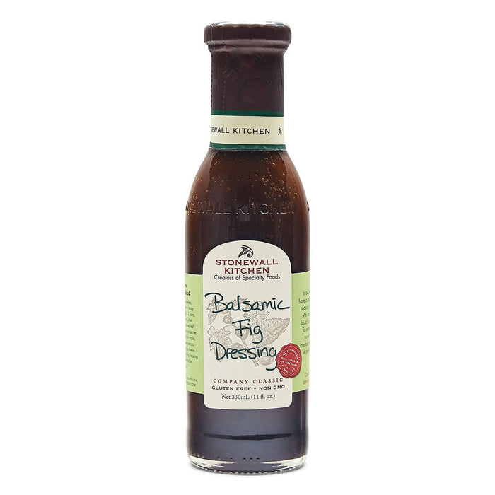 A bottle of STONEWALL KITCHEN-BALSAMIC FIG DRESSING by STONEWALL KITCHEN, featuring a brown liquid and a green and cream label with handwritten-style text—ideal as a flavorful salad dressing.