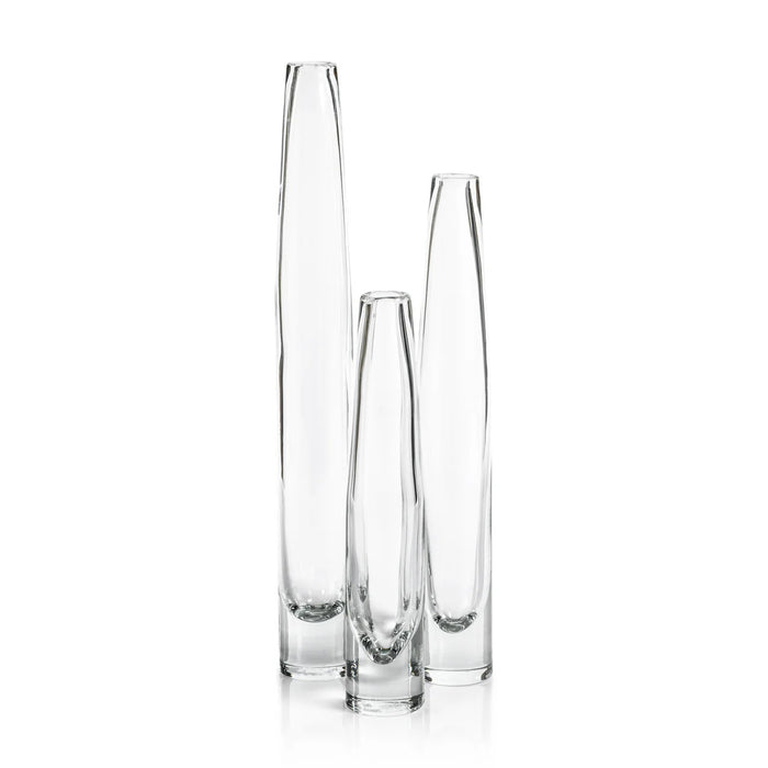 The ZODAX TATE SLIM CLEAR GLASS VASE - SHORT, featuring a narrow neck and wider base, measures 2.5 in x 13.5 in and is shown against a plain white background.