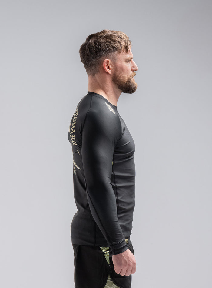 Staz Is 5ft 8" And Wears Size: S | Hem Studio Image Of Model Wearing Thrudark X Scramble Long Sleeve Rash Guard In Obsidian Black (SS Model)
