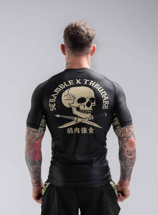 Staz Is 5ft 8" And Wears Size: S | Hem Studio Image Of Model Wearing Thrudark X Scramble Rash Guard In Obsidian Black (SS Model)