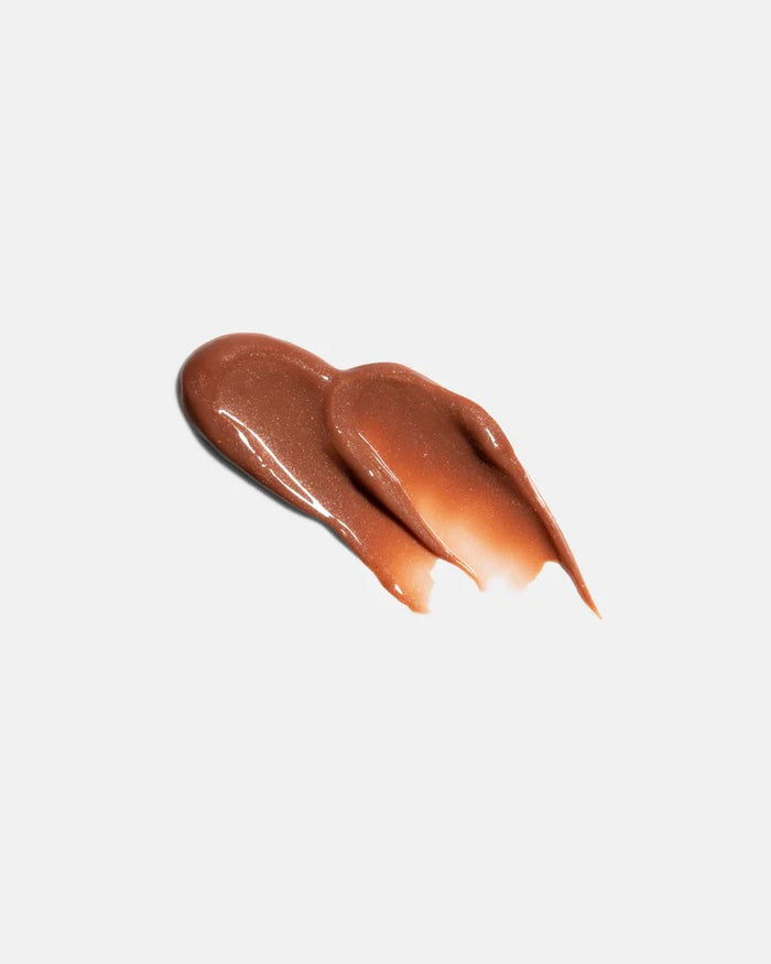 A light gray tube labeled "U BEAUTY - THE PLASMA LIP COMPOUND 15ML" with a screw cap stands upright on a white background, offering advanced hydration and plumping for lips. Brand: U BEAUTY.