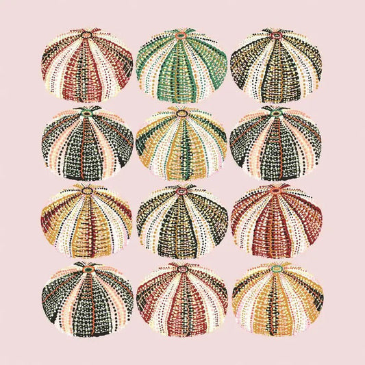 The URCHINS BEVERAGE NAPKINS by PAPER PRODUCTS DESIGN feature twelve uniquely patterned sea urchin shells, arranged in a 4x3 grid against a light pink background, showcasing shades of green, orange, pink, and brown. Made in Germany.