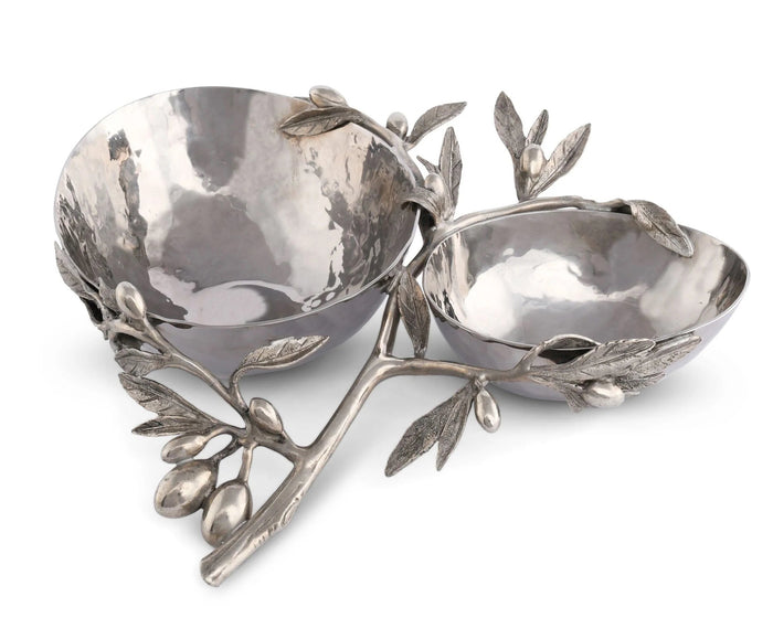 The VAGABOND HOUSE OLIVE DOUBLE SERVING BOWL features two hammered stainless steel bowls connected by a pewter branch with detailed leaves and olives, combining elegance and function for stylish serving.