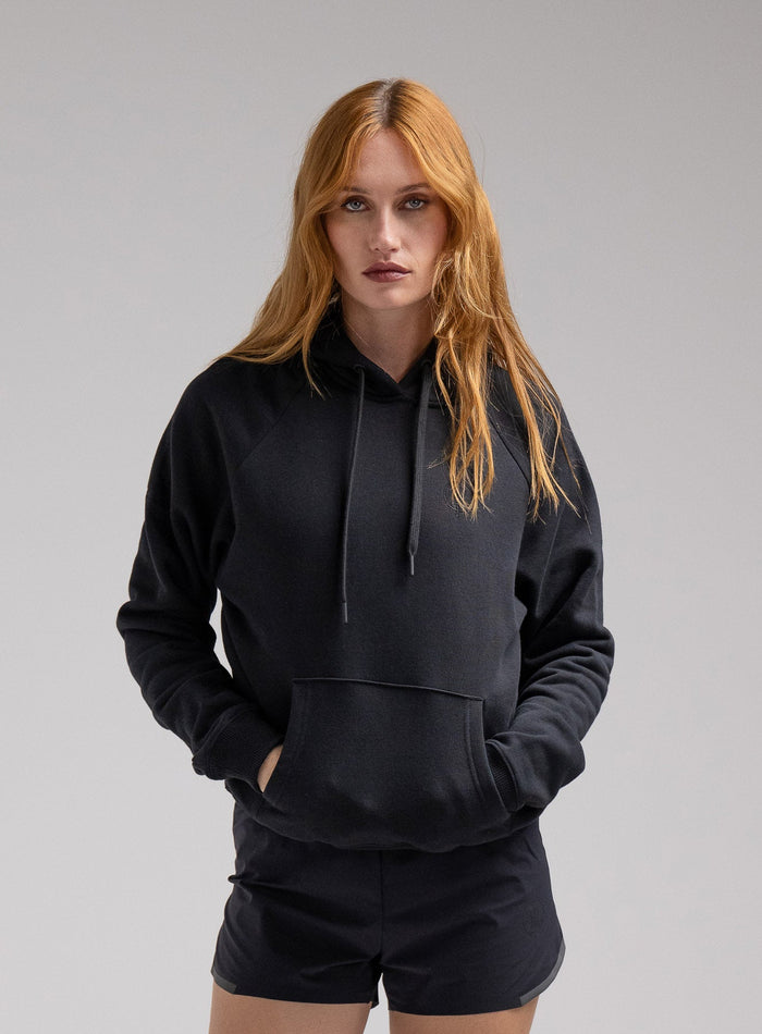 Miki Is 5ft 8" And Wears Size: S | Hem Studio Image Of Model Wearing Valor Hoody In Obsidian Black (SS Model)