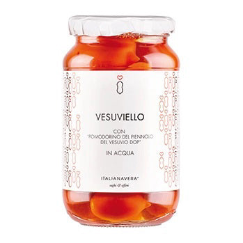 A glass jar of VESUVIO PIENNOLO TOMATOES from ZIA PIA IMPORTS, featuring cherry tomatoes in water. The jar sports a white label with simple decorative designs and reads "Vesuviello con Pomodorino del Piennolo del Vesuvio DOP in acqua.