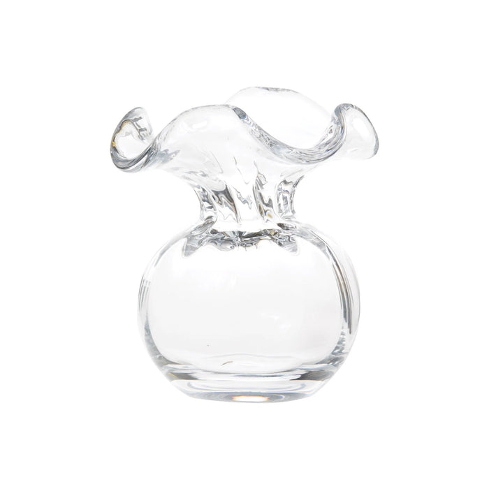 The VIETRI - HIBISCUS BUD VASE CLEAR features a round base and wide, wavy rim, expertly crafted by Tuscan artisans. Displayed against a white background, this clear glass bud vase highlights VIETRI's elegant Italian design.