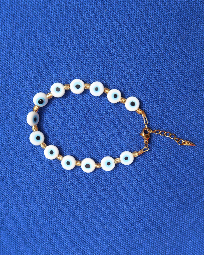 Greek evil eye bracelet with white eye beads and gold accents